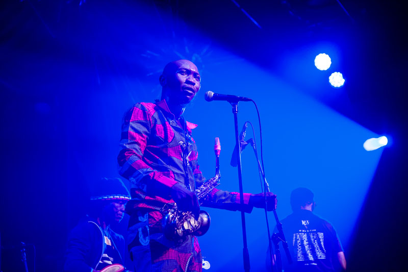 Seun Kuti on stage holding a saxophone